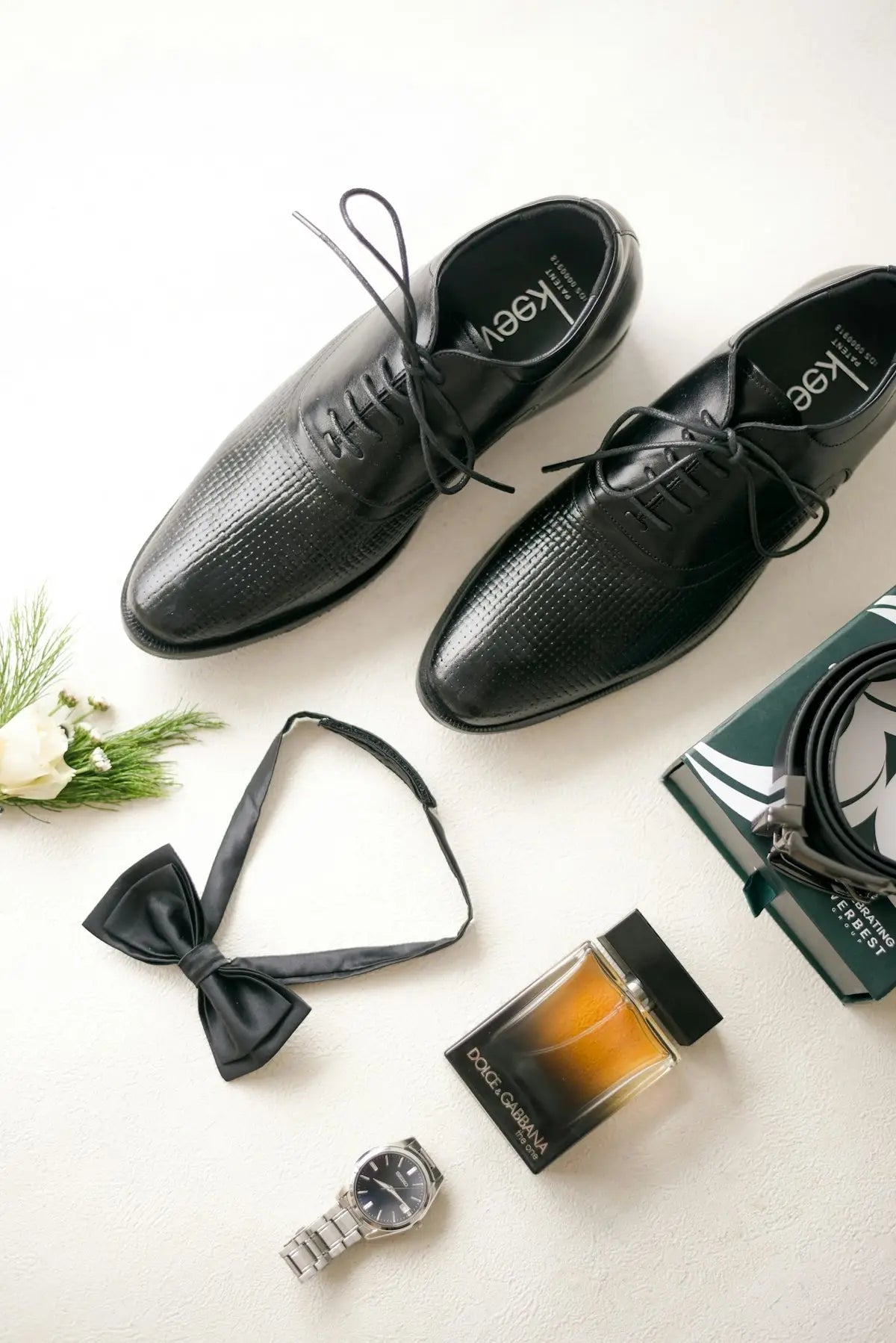 Black leather oxford shoes with laces and pointed toes.