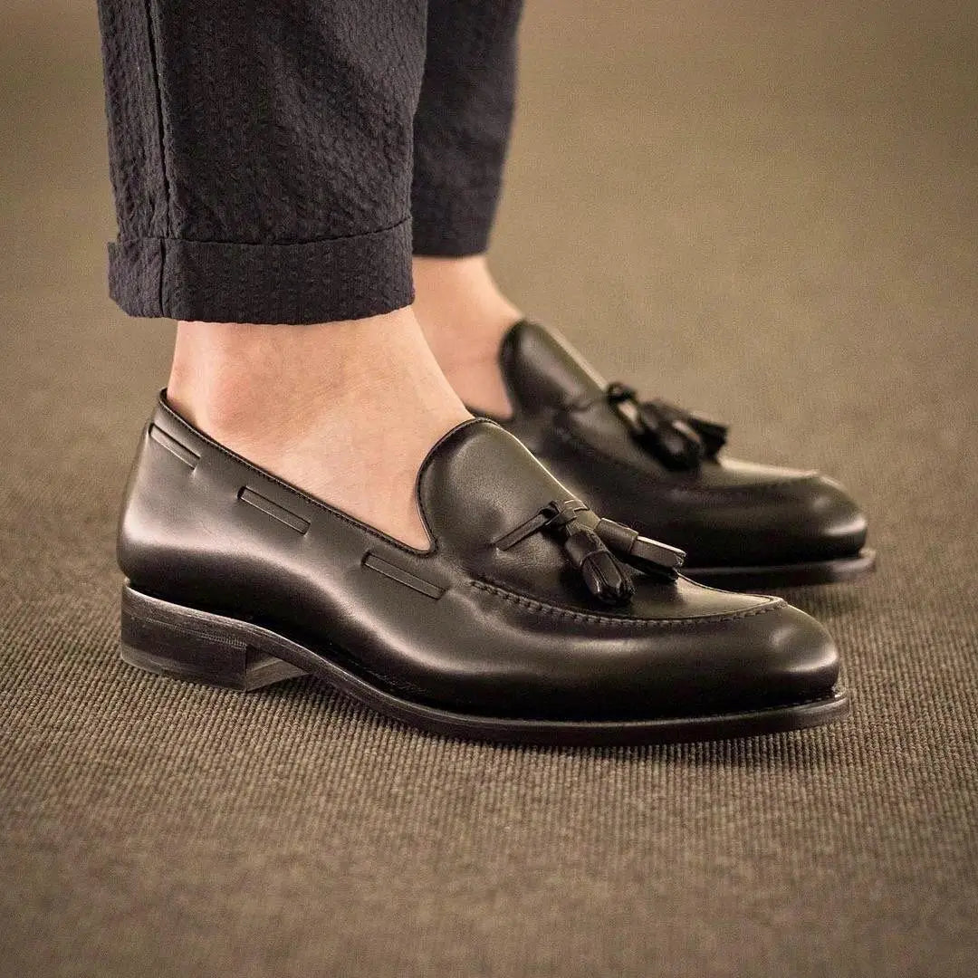 Black leather tassel loafers.