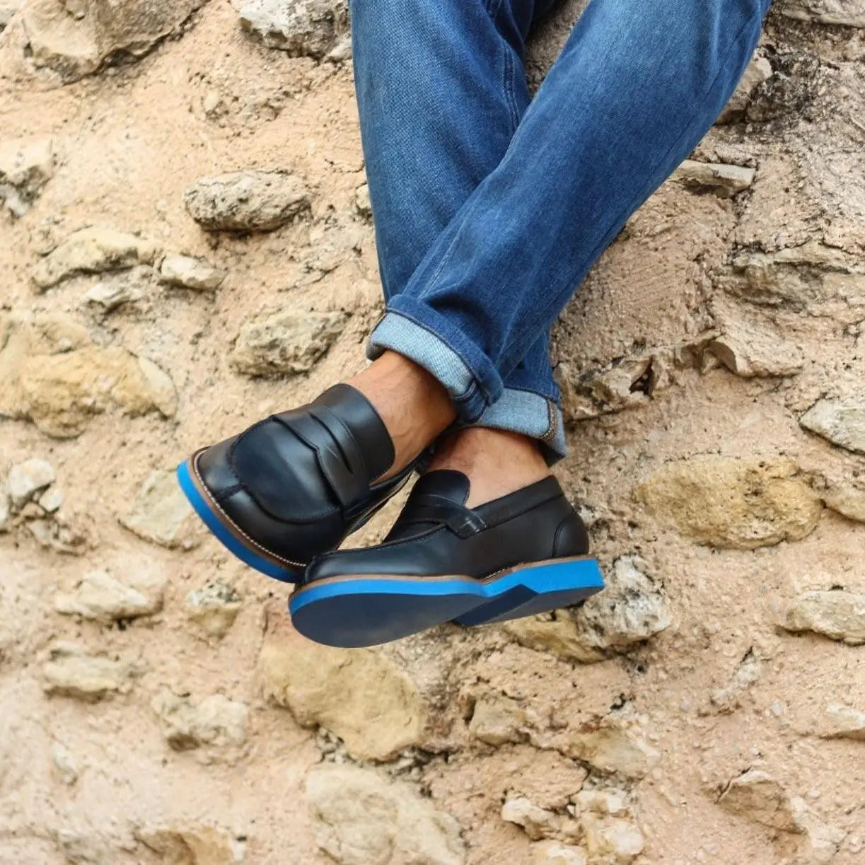 Blue-soled black leather loafers.