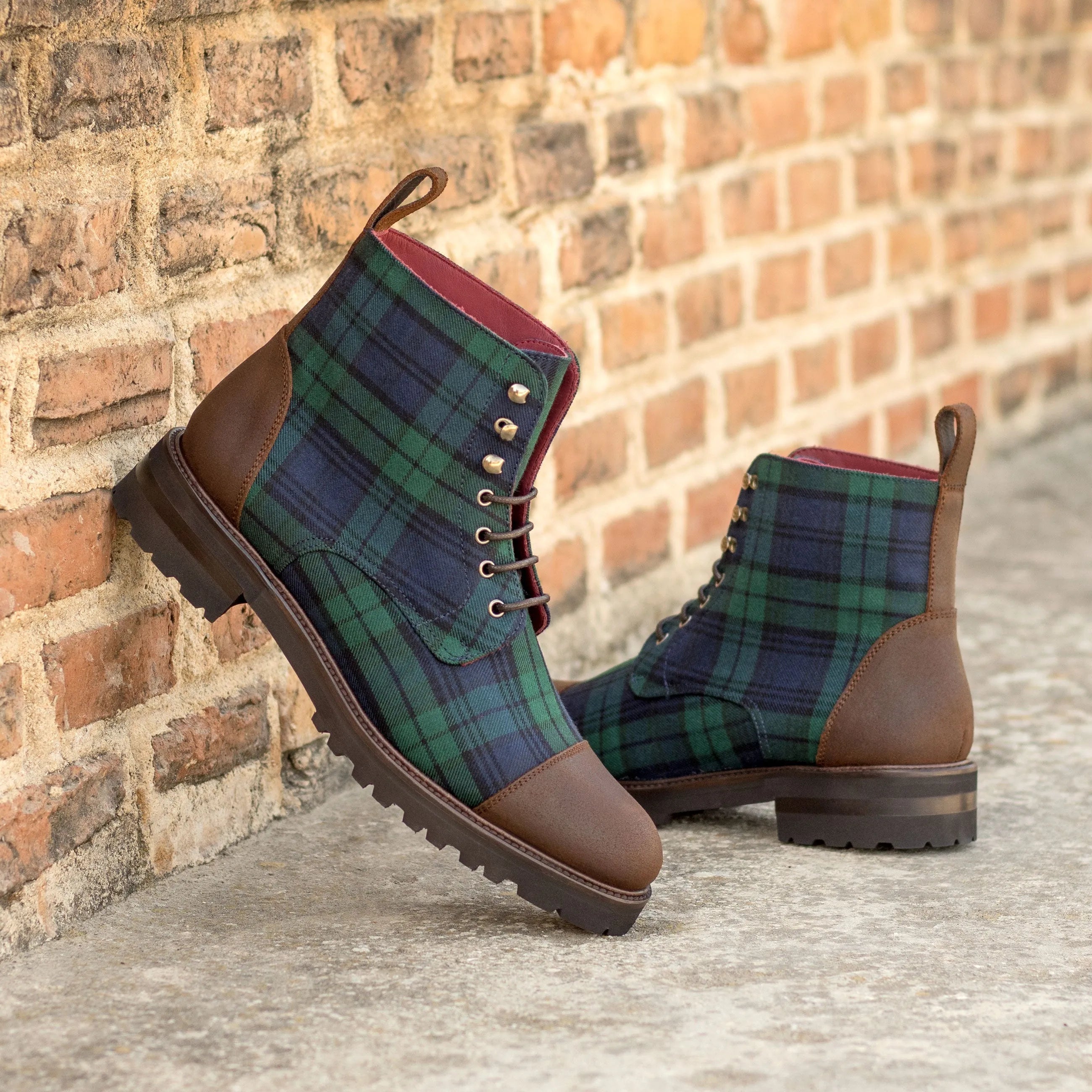 Dark green and navy plaid leather boots with brown toe caps and soles.