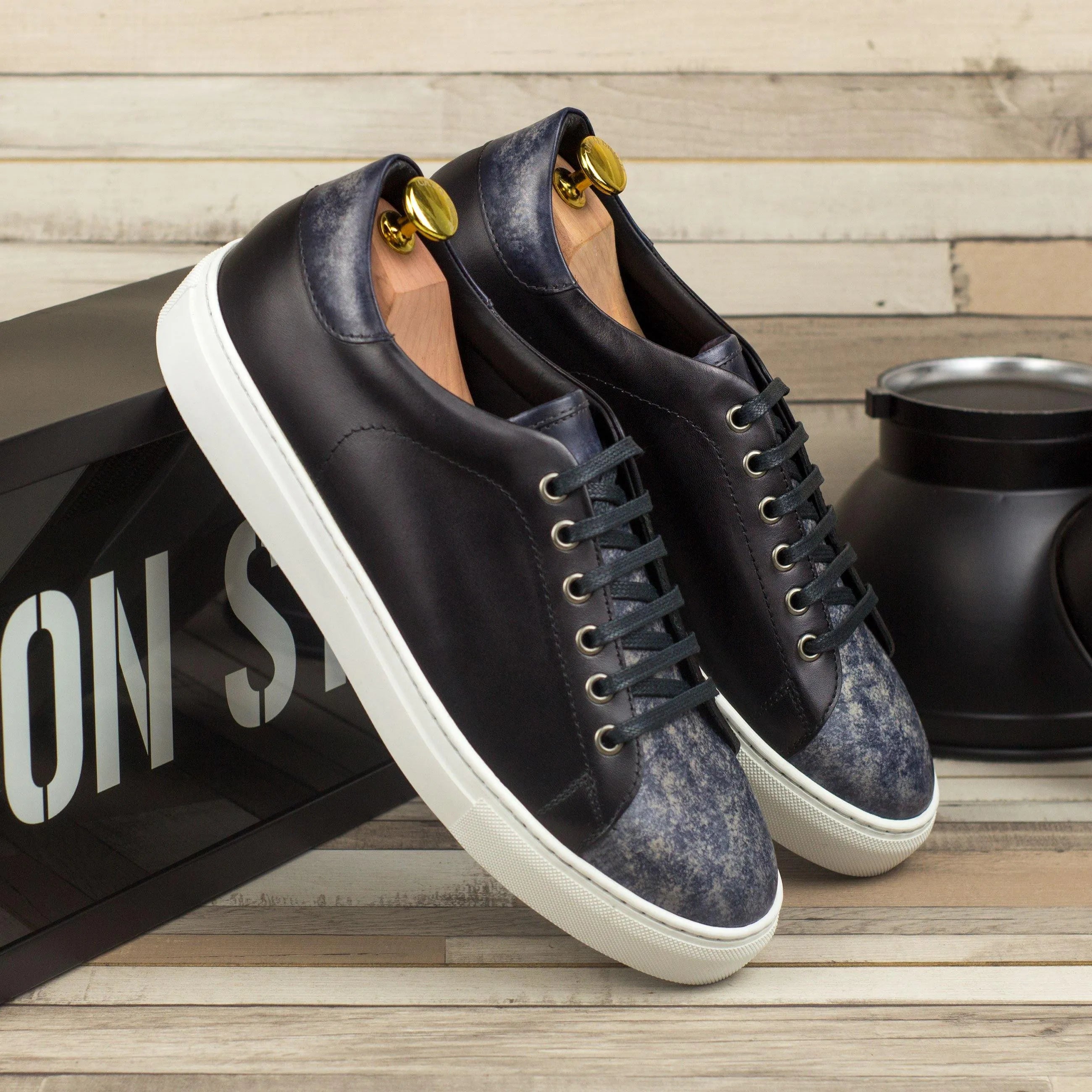 Pair of black leather DTT3 trainer patina sneakers