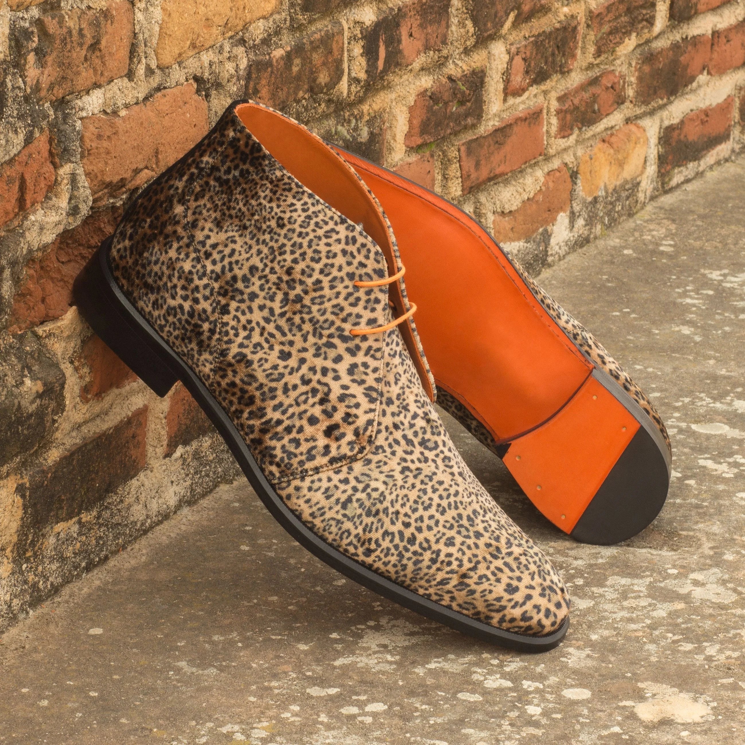 Pardo Chukka boots in leopard print with orange accents and black leather soles