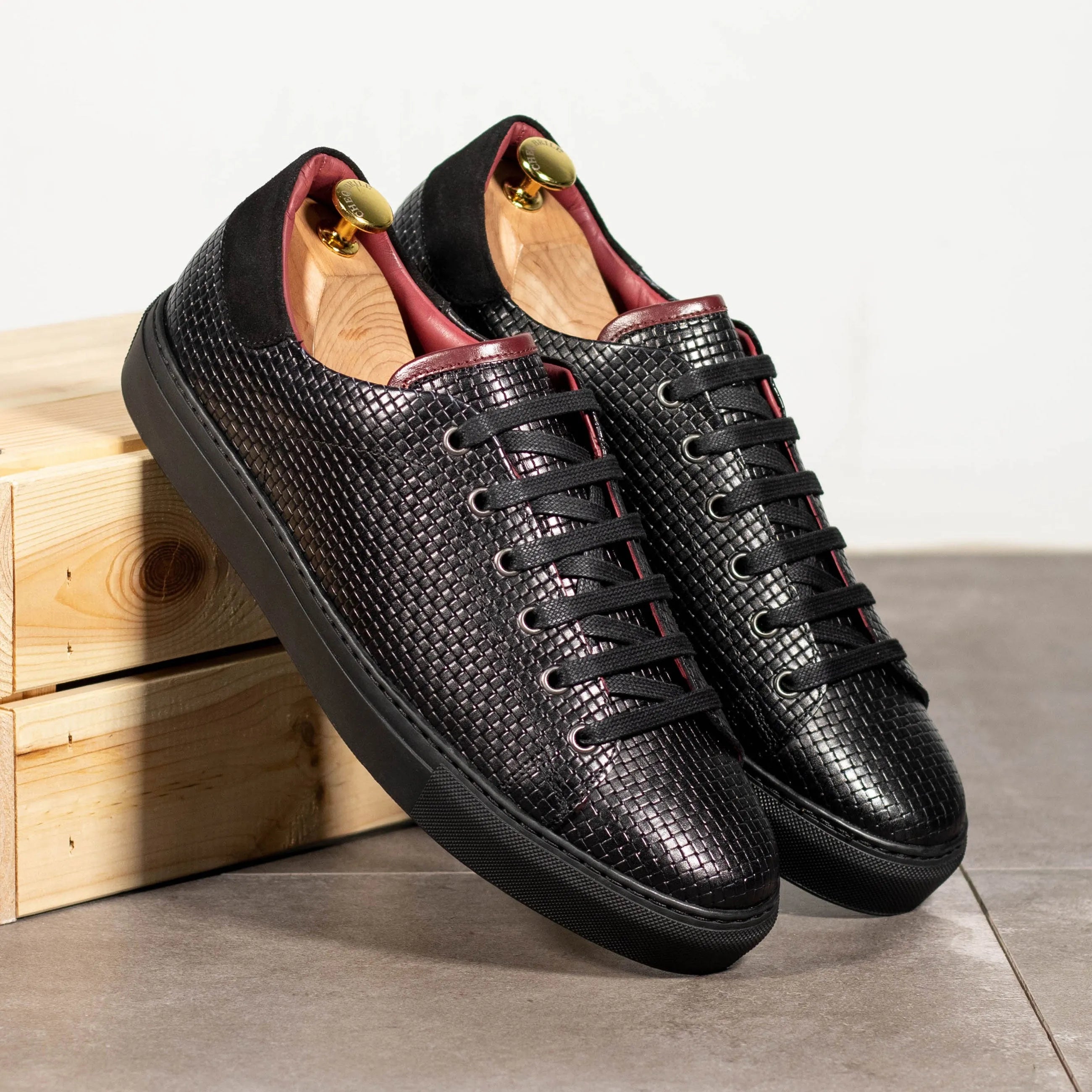 Pair of black textured leather sneakers.