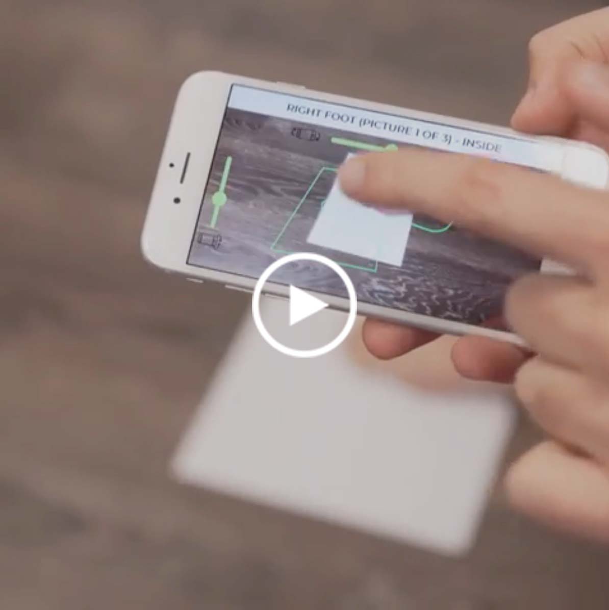 White smartphone displaying a foot measurement app.