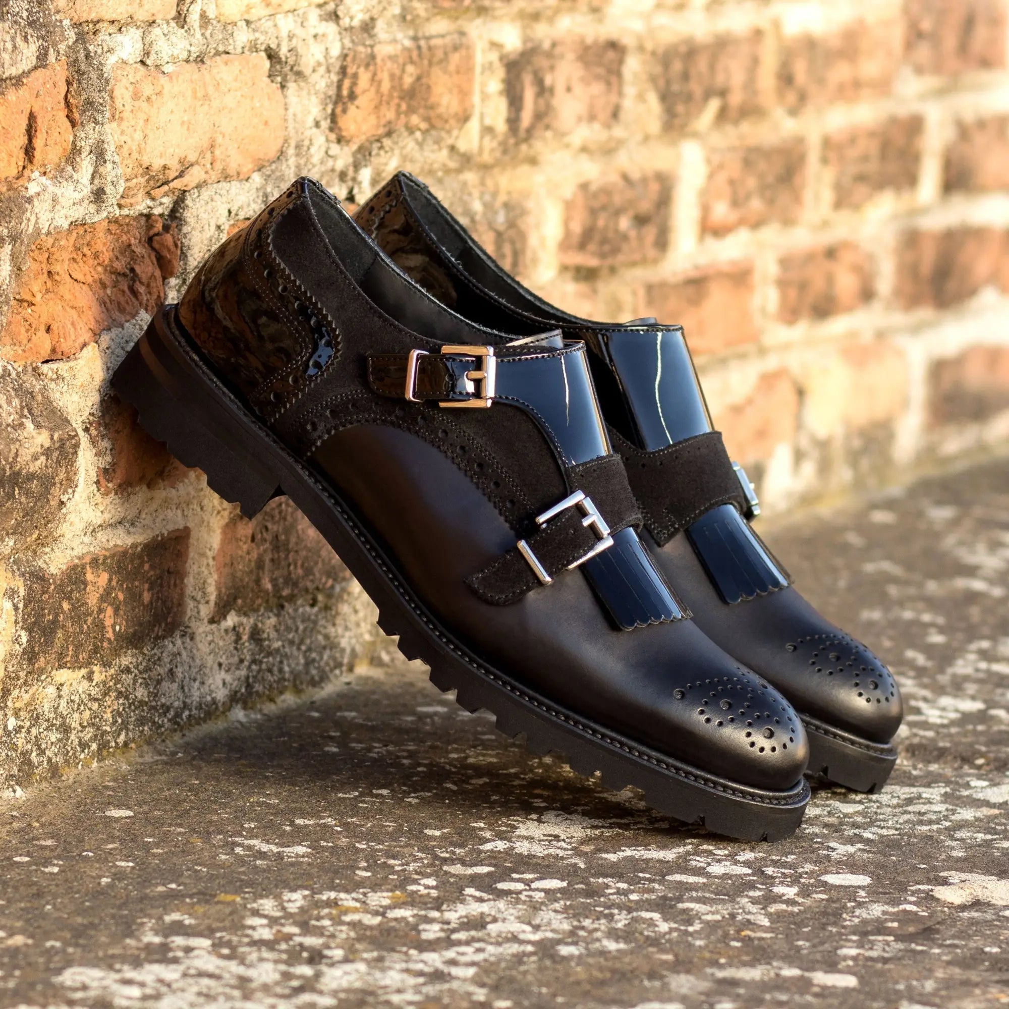 Pair of black leather monk strap shoes.
