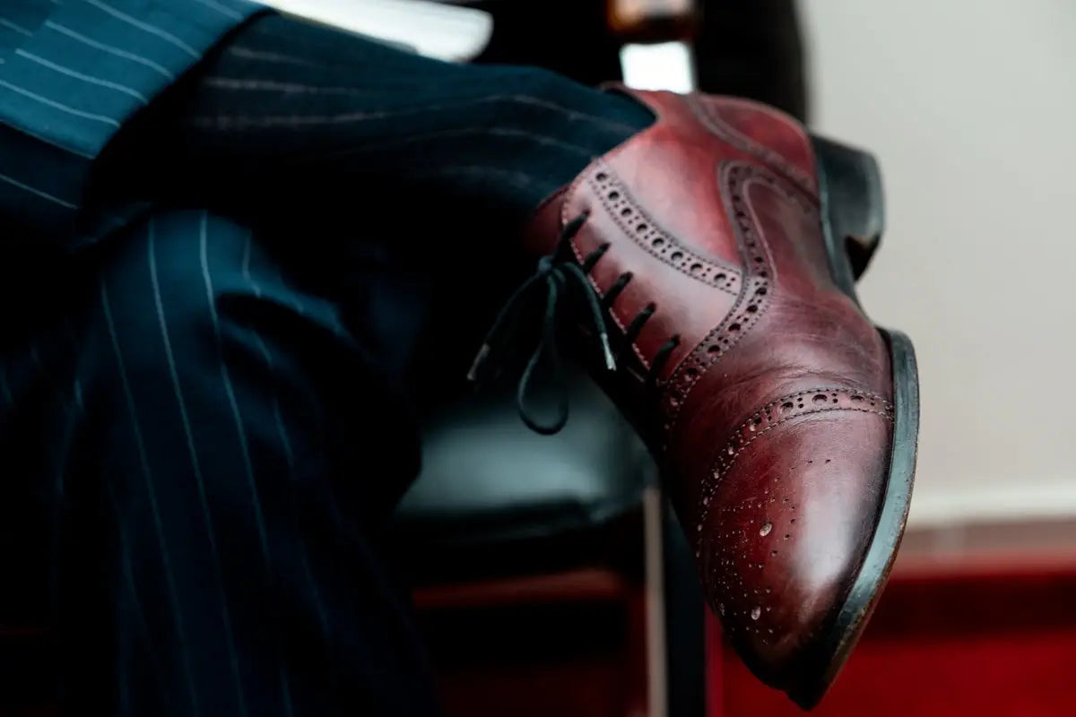 Classic burgundy leather wingtip oxford shoe with intricate brogue detailing and polished finish.