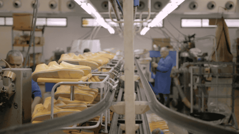 Yellow bread loaf on conveyor belt