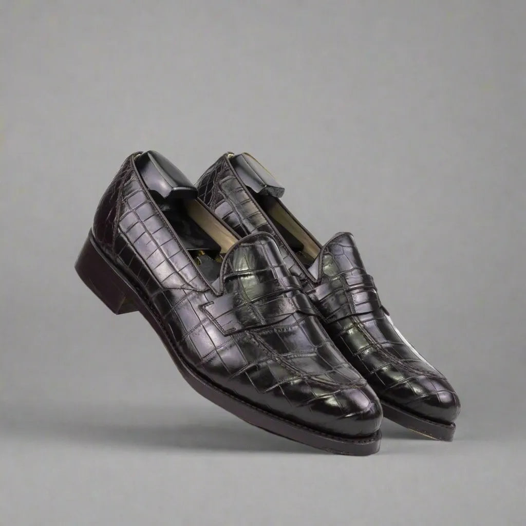 Black crocodile-embossed leather loafers with a polished finish and classic slip-on design.