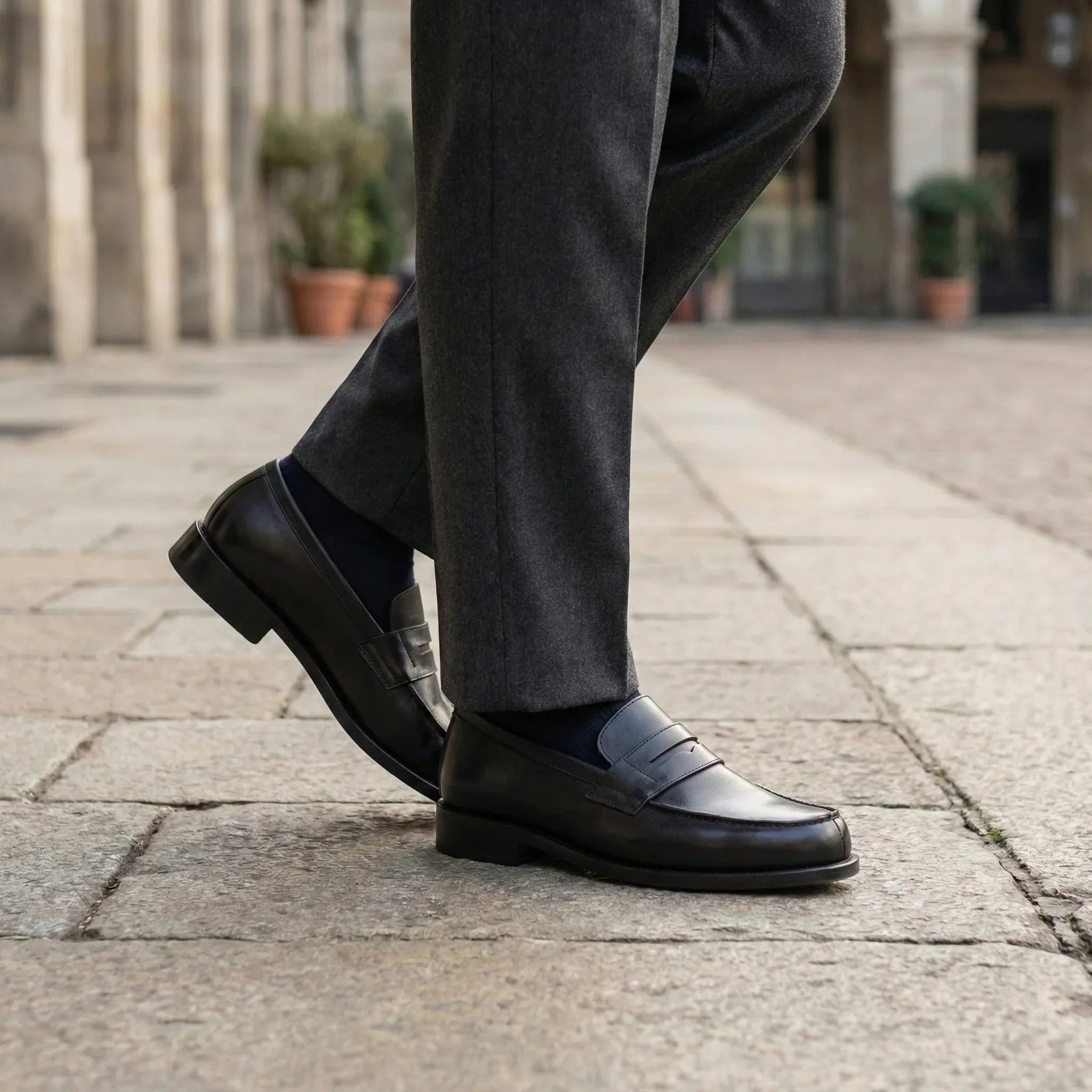 Black leather loafers with a polished finish and a classic slip-on design.