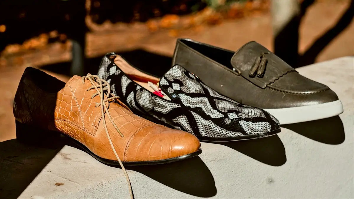 Brown leather oxford shoes with black and white patterned socks, classic tassel detail.