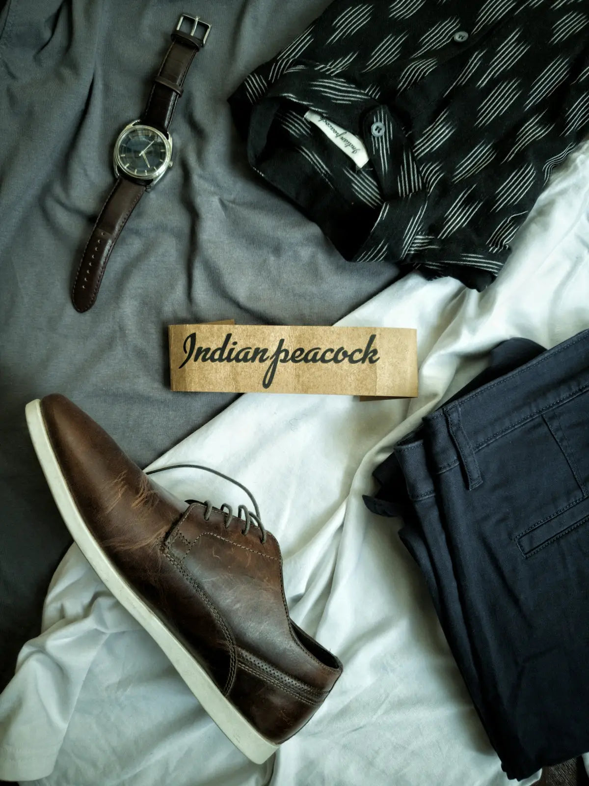 Brown leather chukka boot with white sole and ’indian peacock’ label.
