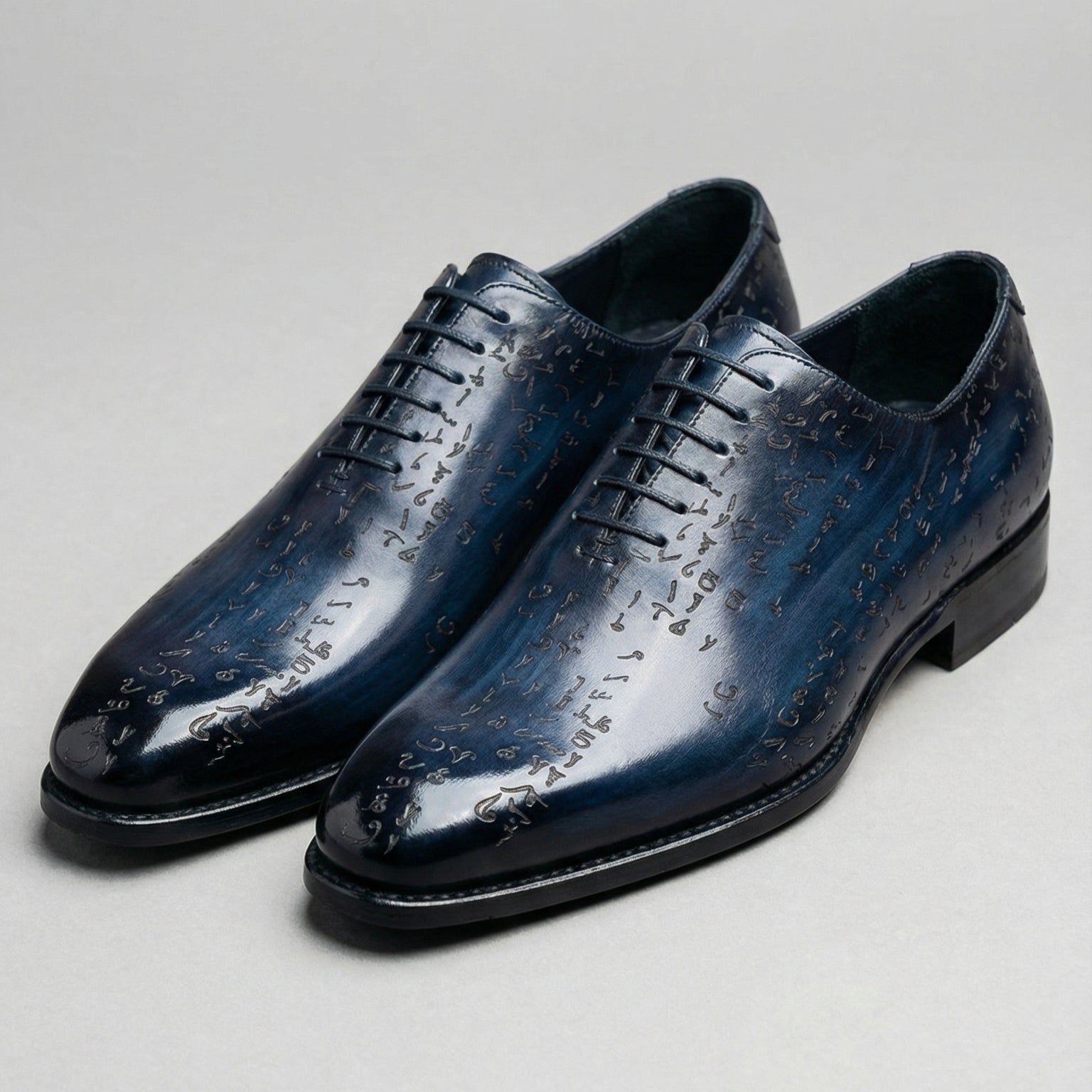 Pair of blue leather dress shoes on a light gray background