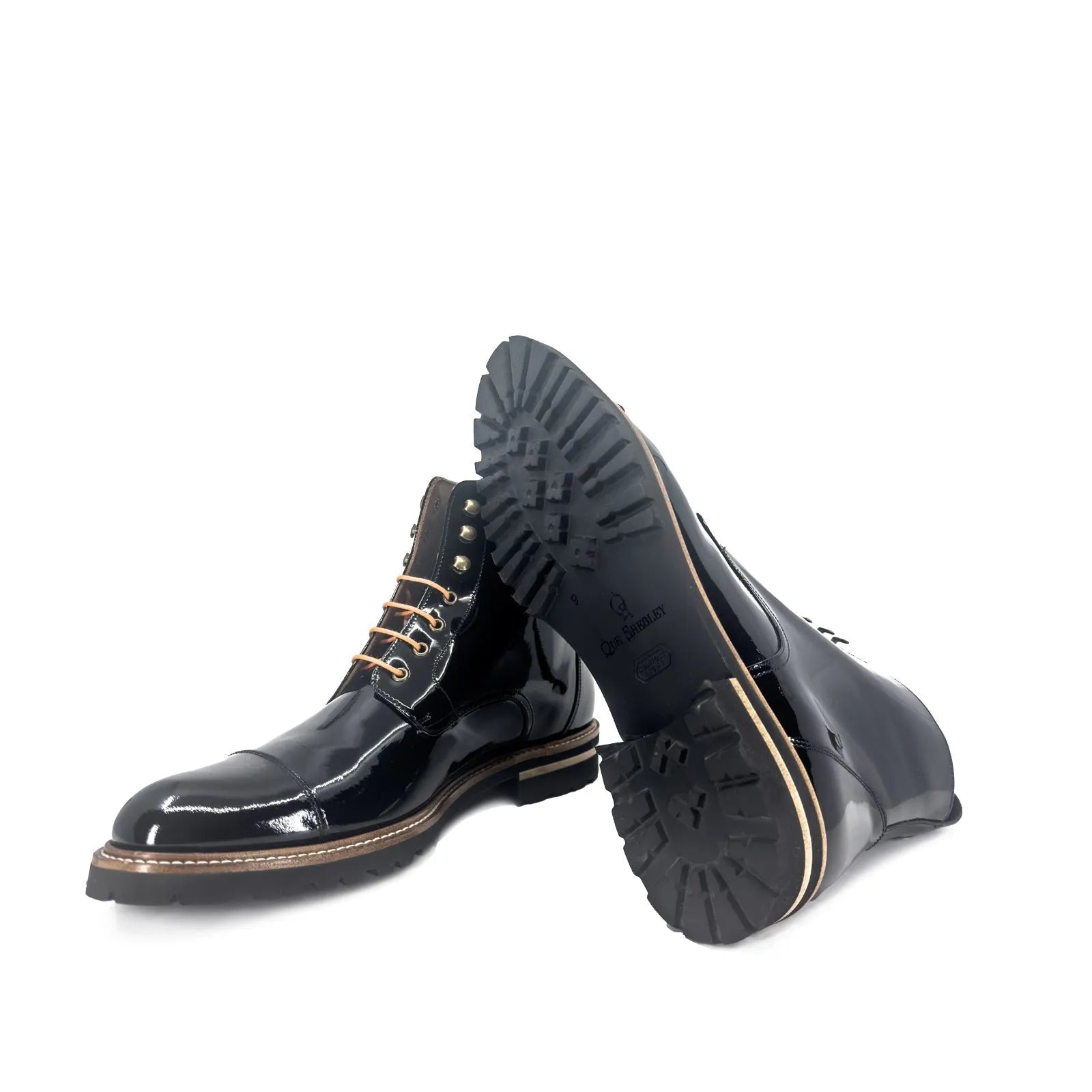 Bossy unisex captoe boots pair of shiny black leather