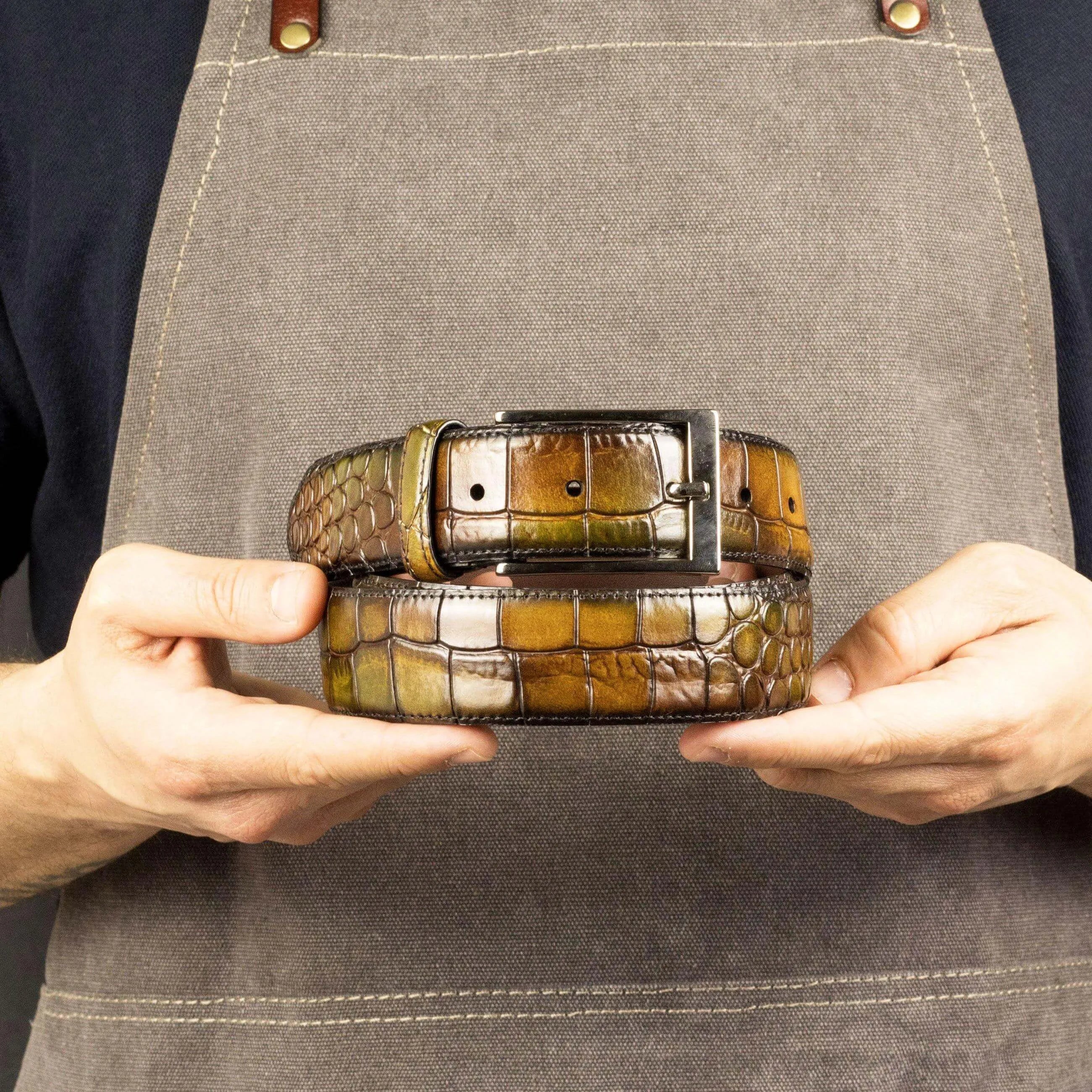 Two stacked Cairo Patina Hamptons belts in multicolored crocodile pattern