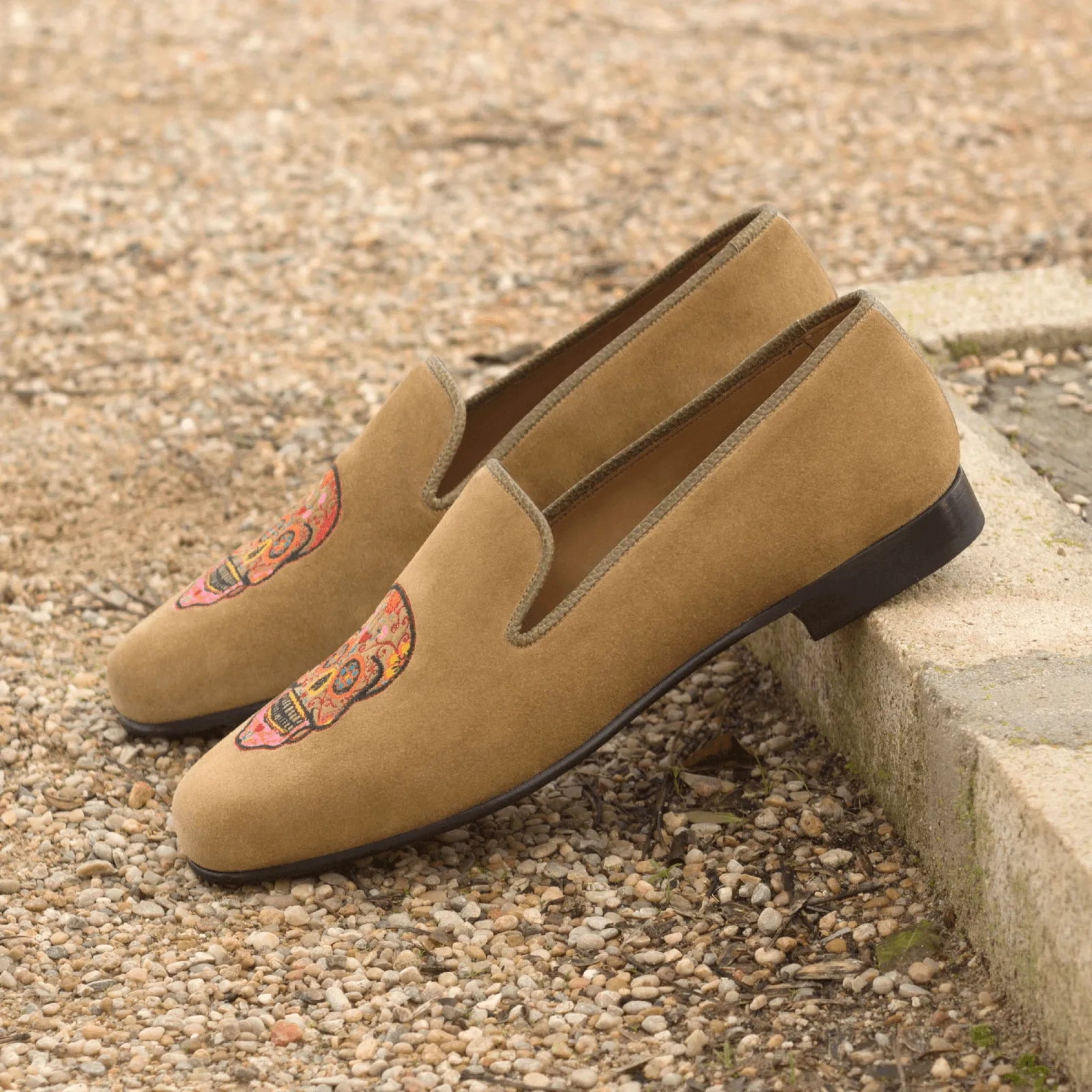 Tan suede Mizrable II Wellington slip on loafers with skull design